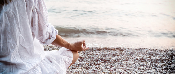 Woman meditating at the sea