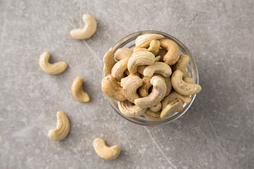 Cashew nuts in the glass bowl on stone table
