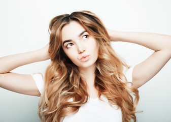 Obraz premium lifestyle and people concept: Young casual woman portrait. Clean face, curly hair. 