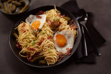 Scampi with fried eggs and bacon in plate