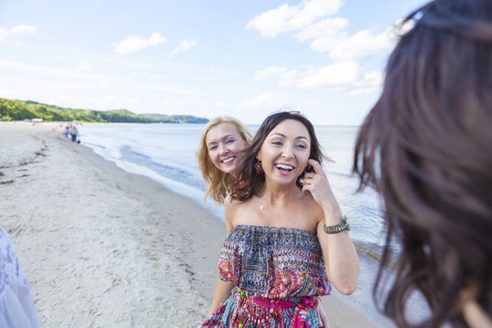 Group of women take a walk along the beach