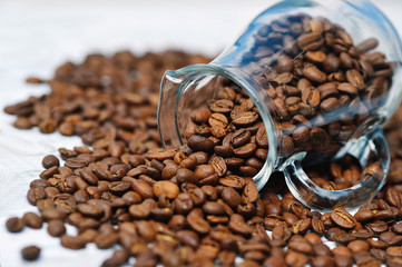 Glass milk jug and coffee beans