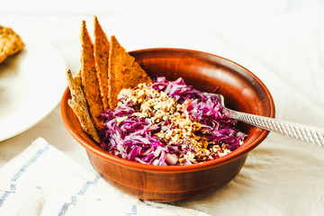 raw red cabbage salad with seeds and.corn crackers