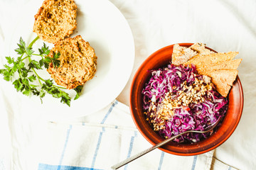 raw red cabbage salad with seeds and.corn crackers, top view