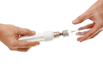 Incandescent and energy-saving lamp in the hands