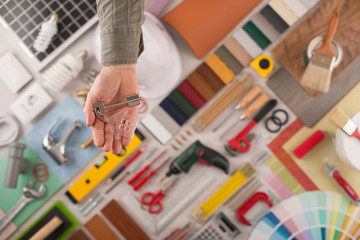 Hand holding house keys