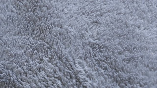 Synthetic fibers of gray polar blanket material close-up 4K 2160p 30fps UltraHD slow tilt footage - Warming polyester fleece fabric silver texture 3840X2160 UHD tilting video