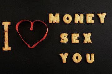 Words money, sex, you made with letters on black