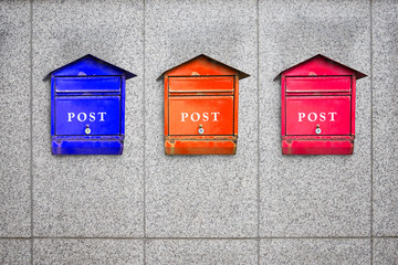 colorful post boxes on wall