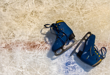 Figured hockey skates on ice background