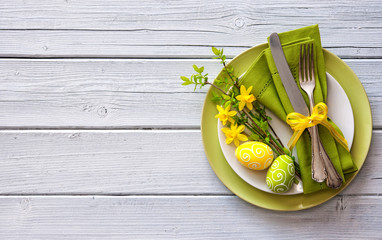 Easter table setting with daffodil and cutlery