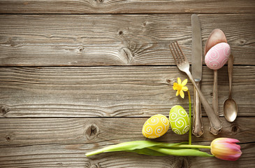 Easter table setting with spring tulips and cutlery