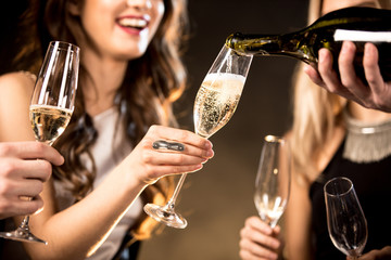 Happy friends drinking champagne - obrazy, fototapety, plakaty