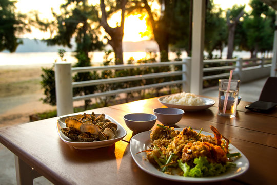 dining table with seafoods with golden light on sunset at seafoo