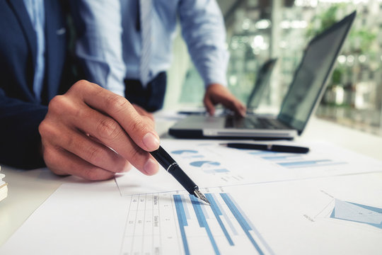 Business concept. Business people discussing the charts and graphs showing the results of their successful teamwork.