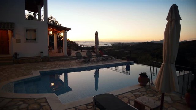 Camera tracking during sunrise at a beautiful Mediterranean villa with swimming pool