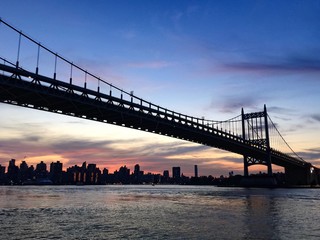 Silhoutte of Triborough bridge and the Manhattan city, New York