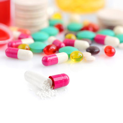 Colored pills, capsules and vitamins isolated on a white background