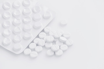 White pills on a white background (with space for text)