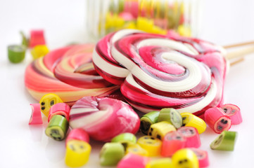Colorful candies and lollipops on a white background