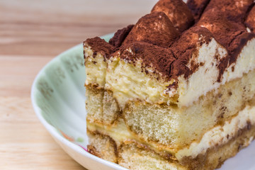 Cake On Dish On Wooden Table Background