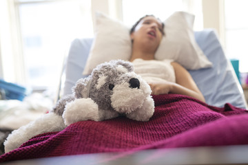 Sick patient lying on bed in hospital for medical background