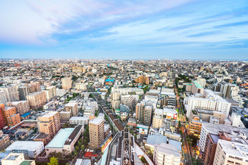 Business and culture concept - panoramic modern city skyline bird eye aerial view under dramatic sunset glow and beautiful cloudy sky in Tokyo, Japan