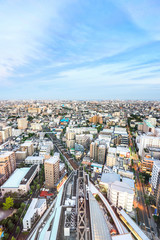 Fototapeta premium Business and culture concept - panoramic modern city skyline bird eye aerial view under dramatic sunset glow and beautiful cloudy sky in Tokyo, Japan