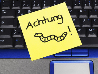 Memo note on notebook, attention with drawing of a worm