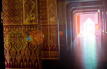 opening door of thai temple with sunlight and lai thai