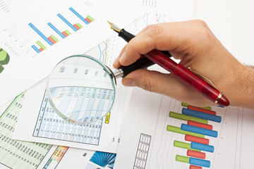 magnifying glass in hand and paper