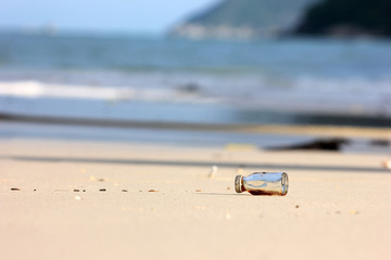 Fototapeta na wymiar Medicine bottle with shade from the sun on the beach. 