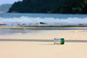 Beverage bottle with shade from the sun on the beach 