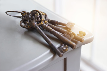 Old rusty keys on the table background