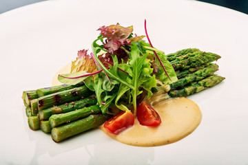 Grilled asparagus with tomatoes and arugula.