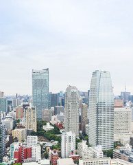 Obraz na płótnie Canvas Business and culture concept - panoramic modern city skyline bird eye aerial view from tokyo tower under dramatic morning blue cloudy sky in Tokyo, Japan