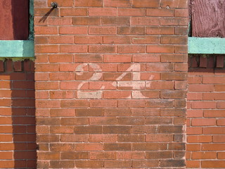 Brick wall with number 24 stencil