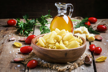 Ingredients for cooking pasta, old wooden table, rustic style, s