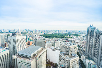 Fototapeta premium Business and culture concept - panoramic modern city skyline bird eye aerial view of Meiji Shrine under dramatic sun and morning blue cloudy sky in Tokyo, Japan