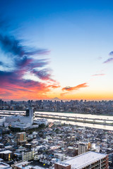 Business and culture concept - panoramic modern city skyline bird eye aerial view with Mountain Fuji under dramatic sunset glow and beautiful cloudy sky in Tokyo, Japan