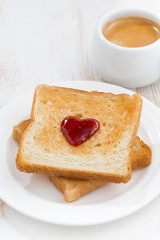 toast with jam in the shape of a heart and coffee, top view