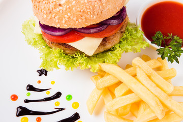 burger sauce and french fries on a white plate close up (top view)