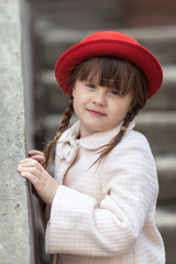  child girl  hat and coat walks  stone stairs