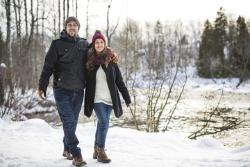 Fototapeta na wymiar Pregnant couple have fun in winter nature