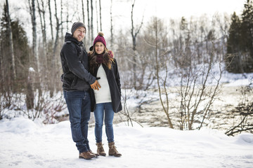 Fototapeta na wymiar Pregnant couple have fun in winter nature