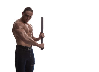 Portrait of a brutal man bodybuilder athlete with naked torso with a baseball bat in his hands on a...