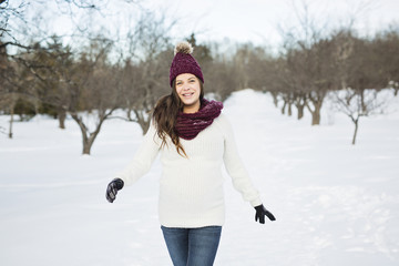 Fototapeta na wymiar Young happy pregnant woman in snowy forest