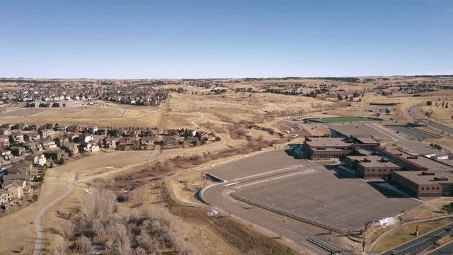 Aerial view ofsuburban high school in snowless Winter