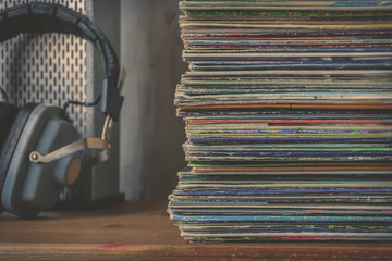 Pile of old vinyl records and headphones
