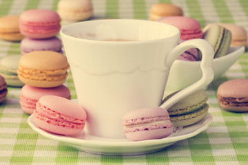 Cup of coffee with sweet macaroon biscuits